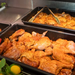 BBQ marinated chicken pieces in the display counter